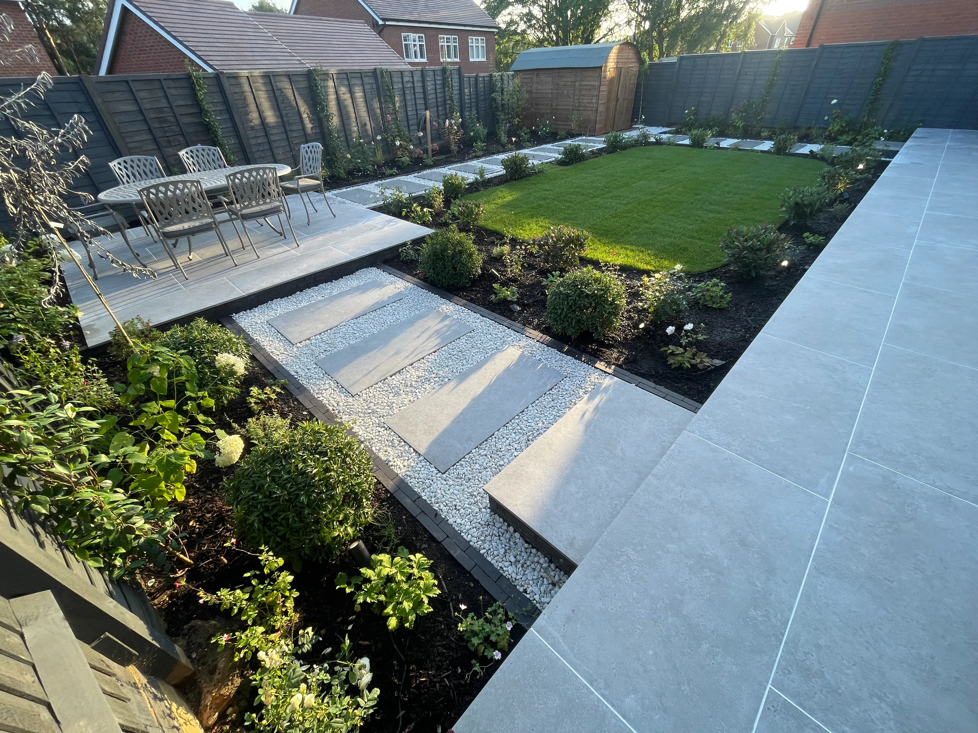 A garden with a lawn and a patio.