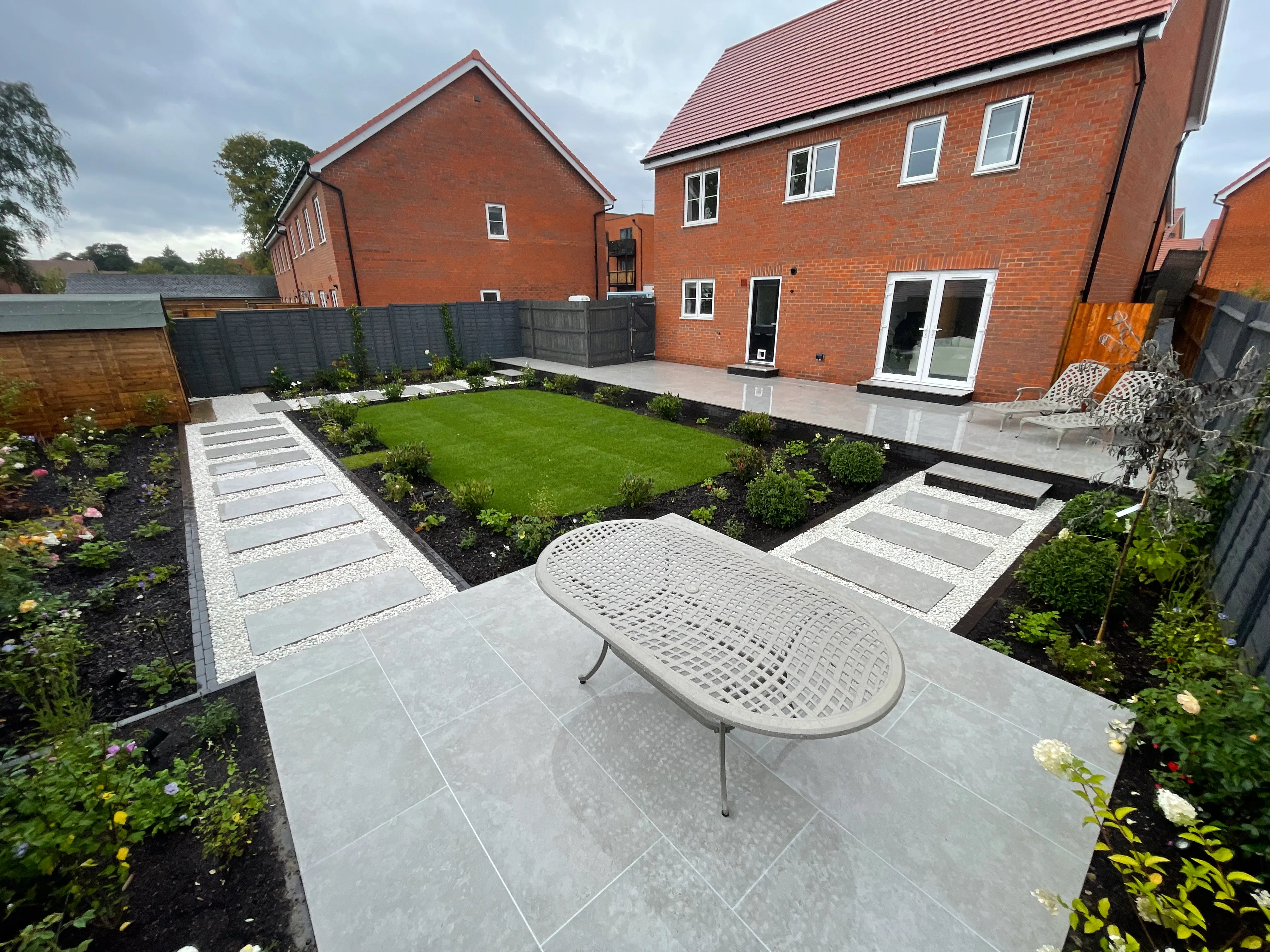 A garden with a table in the middle of it.